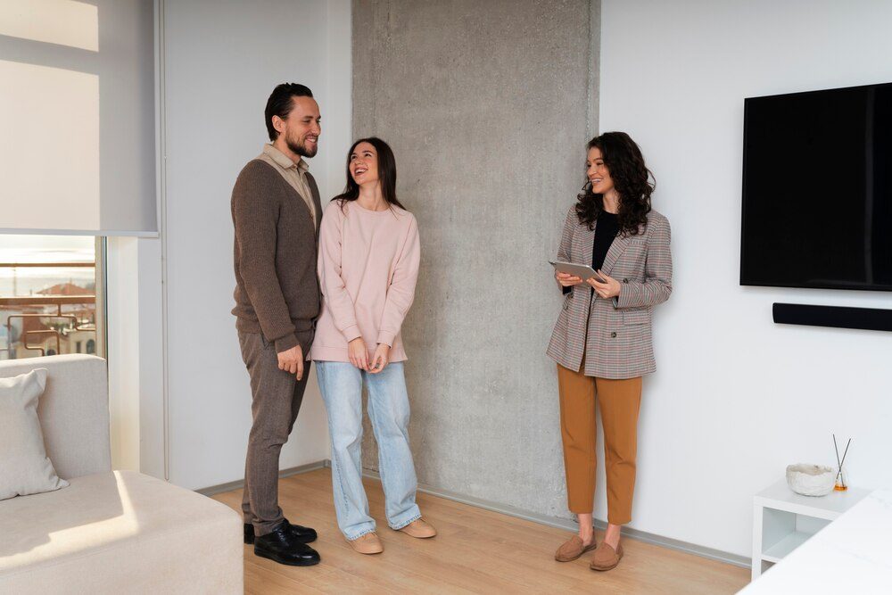 A real estate agent showing a flat to a couple during a viewing