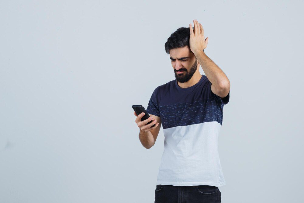 Frustrated user trying to navigate a non-responsive website on their smartphone