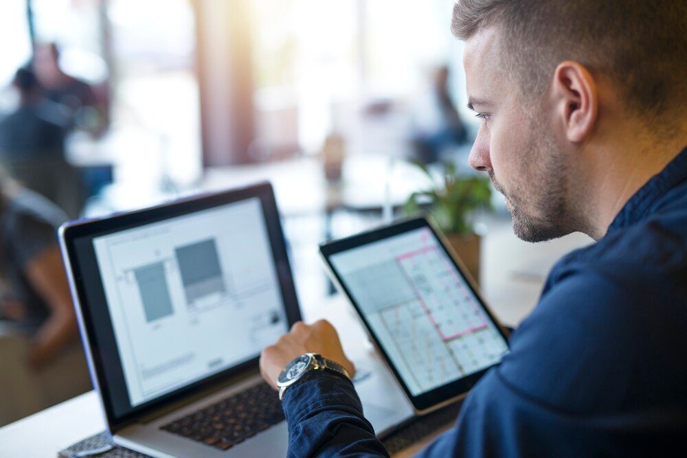 Developer optimizing the responsive design of a website across multiple devices