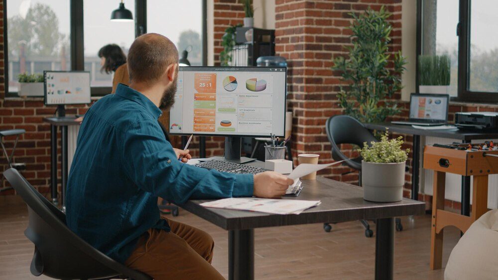 Professional analyzing sales performance charts on a monitor