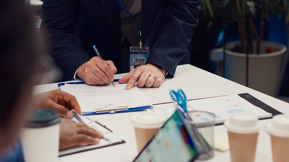 Entrepreneurs signing a partnership contract after reviewing a web project budget