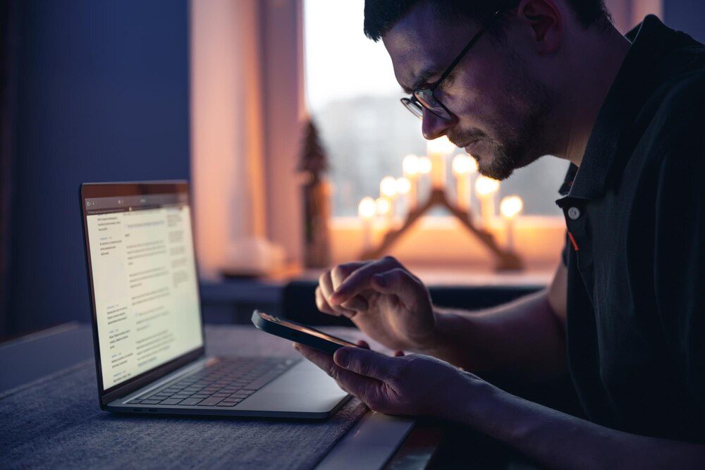 Person checking a suspicious email on a laptop at night