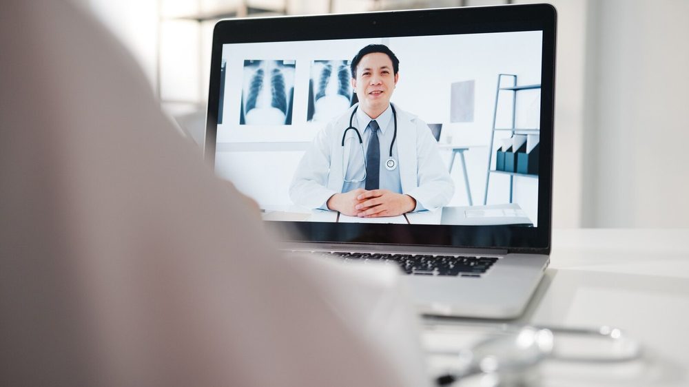 Health professional handling an inquiry on a computer