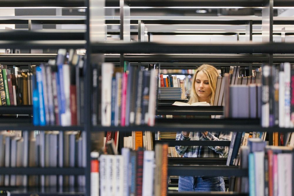 Bookstore shelves with books organized by genre