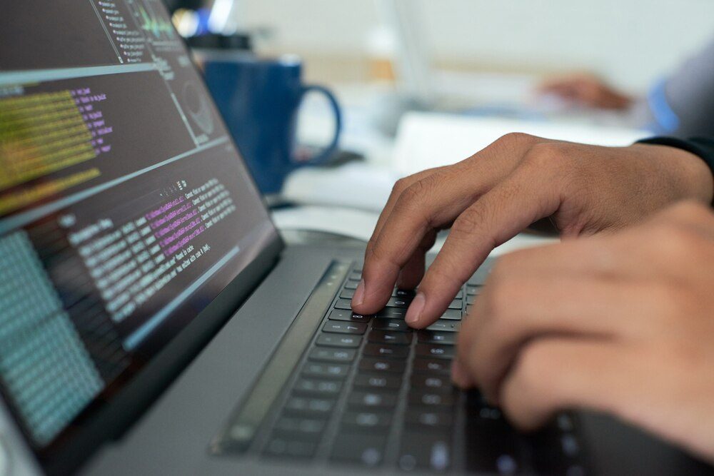 Programmer working on source code on a computer screen