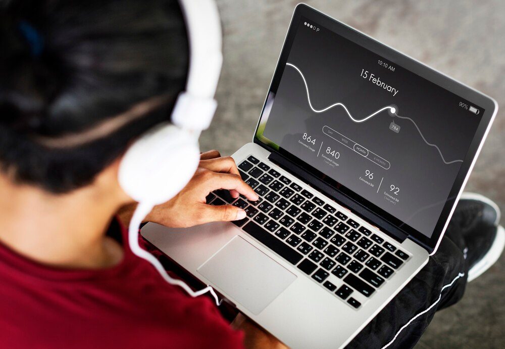 Analyst reviewing website performance and statistics with headphones